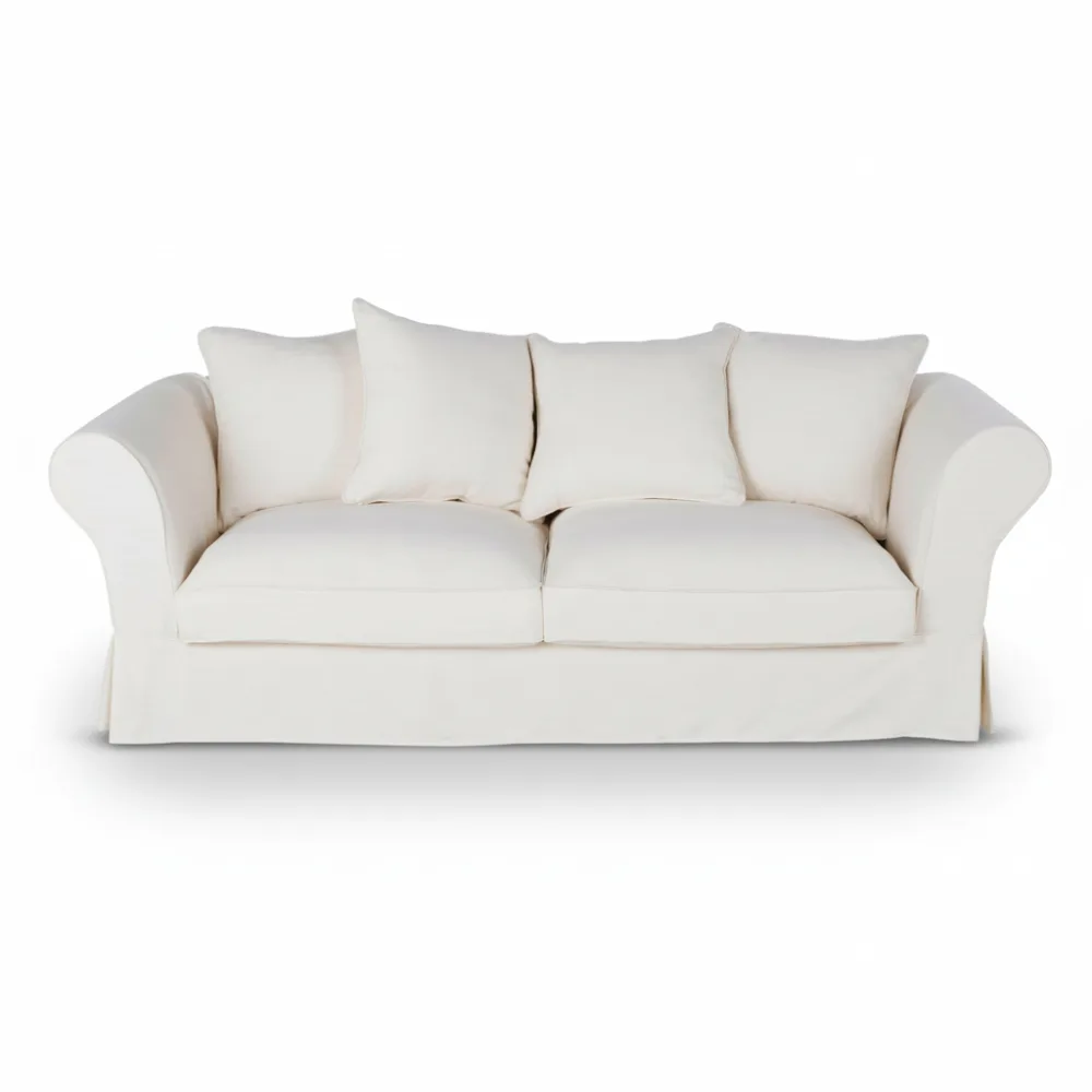 Canapé Roma Maison du Monde en tissu blanc, silhouette droite avec accoudoirs arrondis, coussins assortis et base juponnée, vu de face.