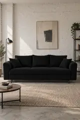 Vue d'ensemble du canapé Rune Maisons du Monde 3 places en velours, coloris noir, style vintage, dans un ancien atelier transformé en logement (mise en situation illustrée par IA)
