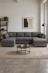 Vue d'ensemble du canapé Times Square Maisons du Monde 6 places convertible en tissu, coloris gris foncé, style contemporain, dans un ancien atelier transformé en logement (mise en situation illustrée par IA)