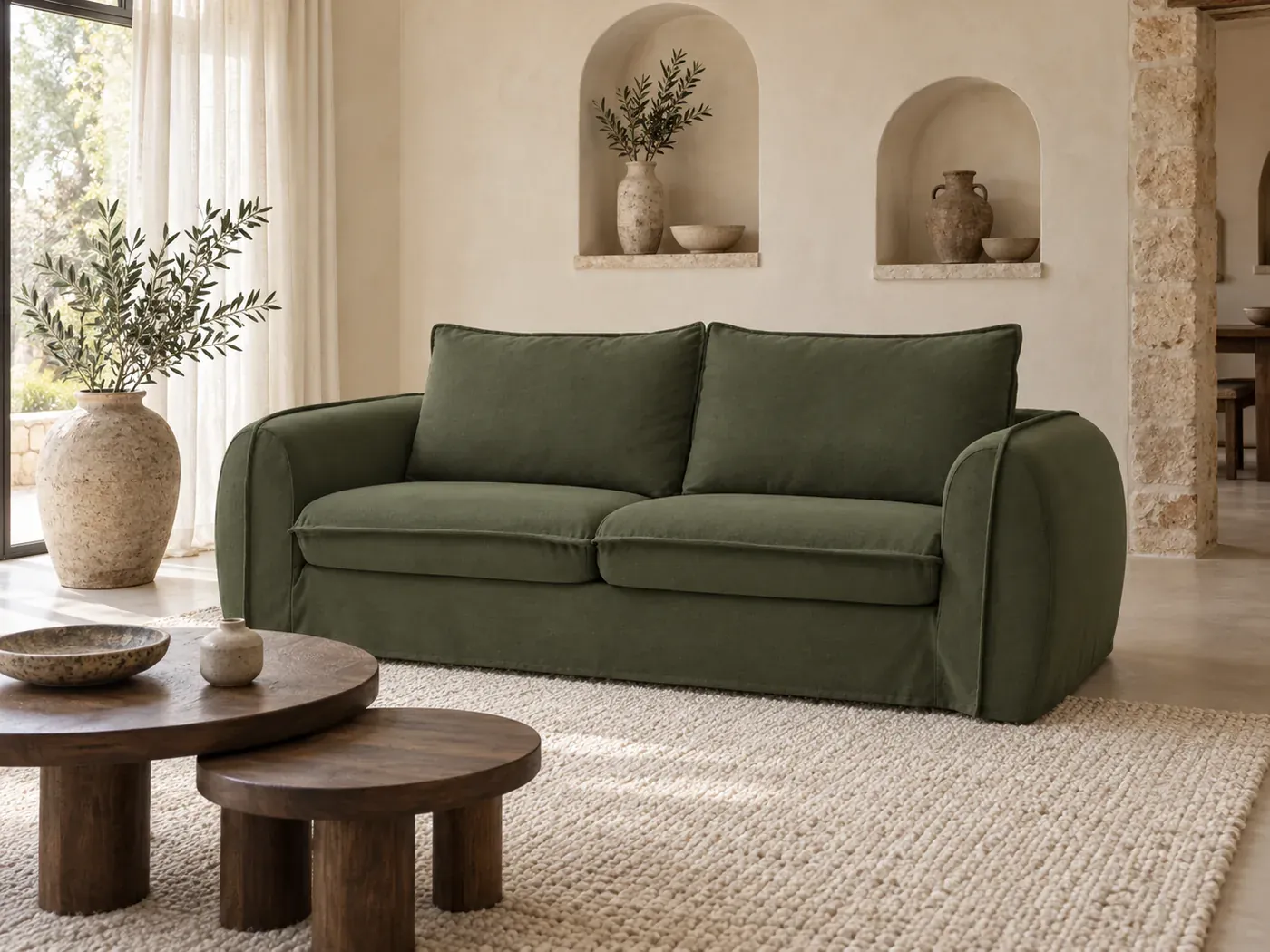 Archimede, 3 places droit convertible express couchage 140x194, coloris vert, dans un séjour de mas aux murs chaulés et aux niches arrondies