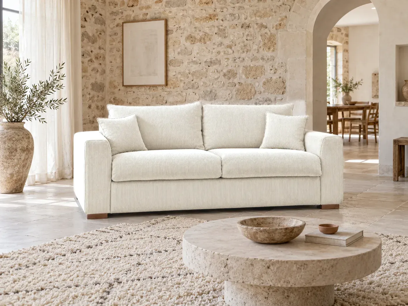 Augustin, 3 places droit convertible express couchage 140x200, velours côtelé, coloris beige, dans un salon en pierre blonde avec une arche chaulée